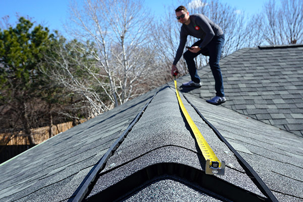 man measuring on the roof